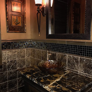 Powder Room featuring marble, custom cabinetry, metallic paint, glass tile, animal print tile, sconce and chandelier lighting and porcelain tile flooring