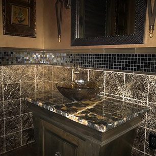 Powder Room featuring marble, custom cabinetry, metallic paint, glass tile, animal print tile, sconce and chandelier lighting and porcelain tile flooring